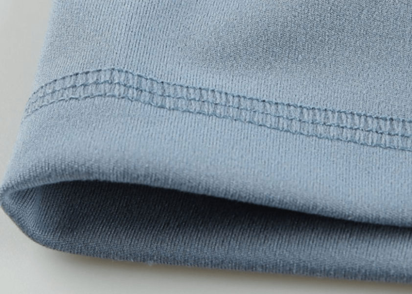 Close-up of blue elastic women's short shorts hem, highlighting polyester-spandex blend for training comfort and flexibility.